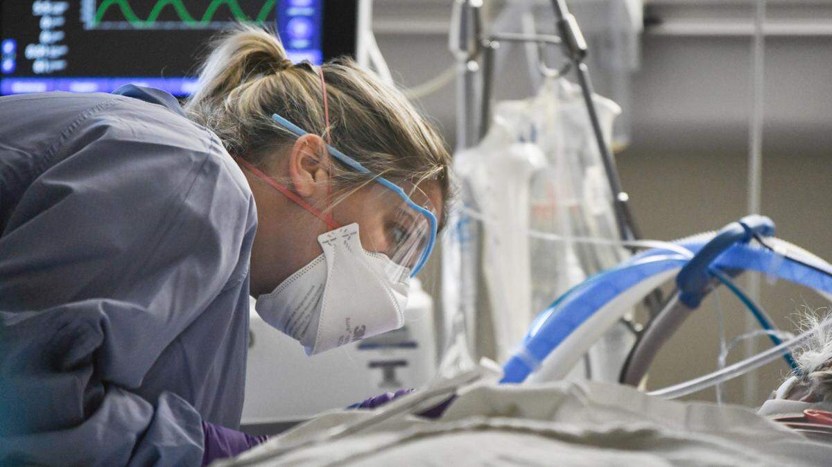 Katie Downey, RN, cares for a COVID patient in the Medical Intensive Care Unit at UNC Hospital in Chapel Hill, N.C. Wednesday, Aug. 11, 2021.