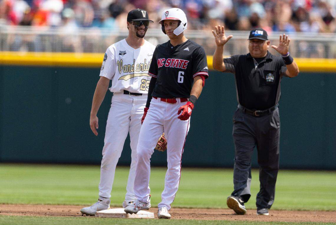 Vanderbilt’s Parker Noland (25), left, smiles as North Carolina State’s Vojtech Mensik (6) reacts after his double is called a foul ball needing further review in the second inning during a baseball game in the College World Series, Friday, June 25, 2021, at TD Ameritrade Park in Omaha.