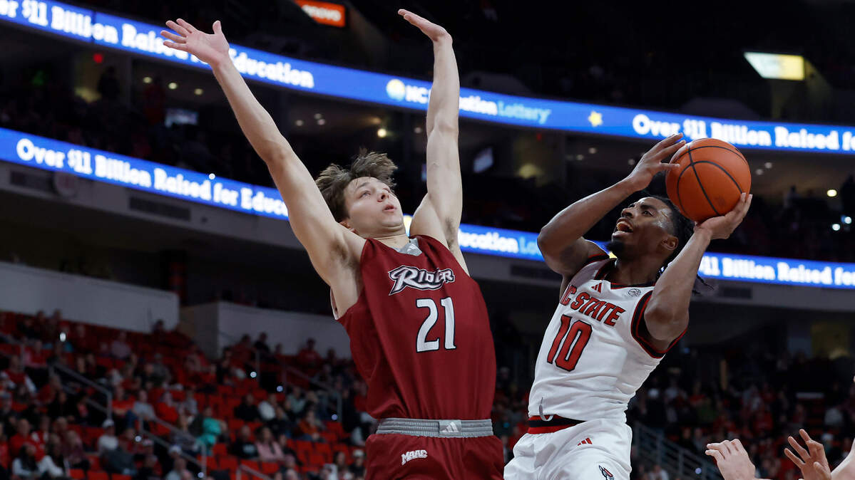 N.C. State’s Marcus Hill drives to the basket against Rider’s Cole McCabe during the first half of the Wolfpack’s game on Sunday, Dec. 22, 2024, at Lenovo Center in Raleigh, N.C.