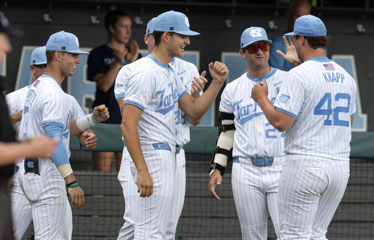 Team members celebrate North Carolina’s pitcher Jake Knapp (42) during UNCÕs game against Holy Cross in the Chapel Hill Regional at Boshamer Stadium in Chapel Hill on Friday, May 30, 2025.