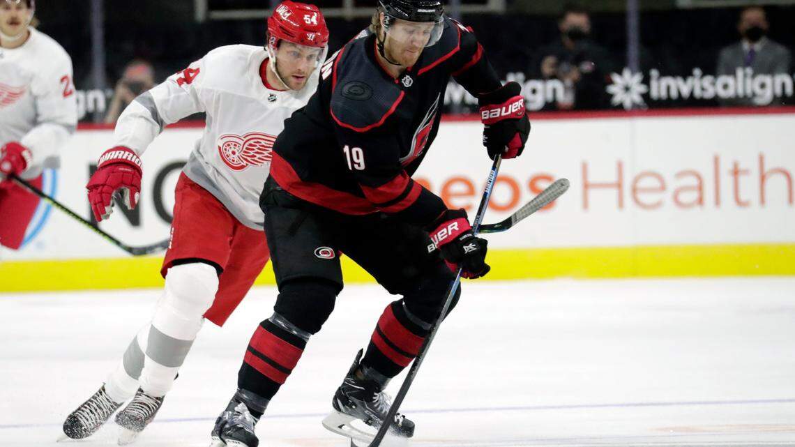 Detroit Red Wings’ Bobby Ryan (54) pursues as Carolina Hurricanes’ Dougie Hamilton (19) moves the puck during the first period of an NHL hockey game in Raleigh, N.C., on Thursday, March 4, 2021. (AP Photo/Chris Seward)