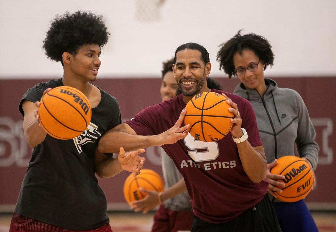 Jarin Stevenson and his uncle Greg Stevenson compete shooting free throws, while Jarin’s mom Nicole Stevenson waits her turn following a pre-season workout on October 26, 2022 in Pittsboro, N.C.