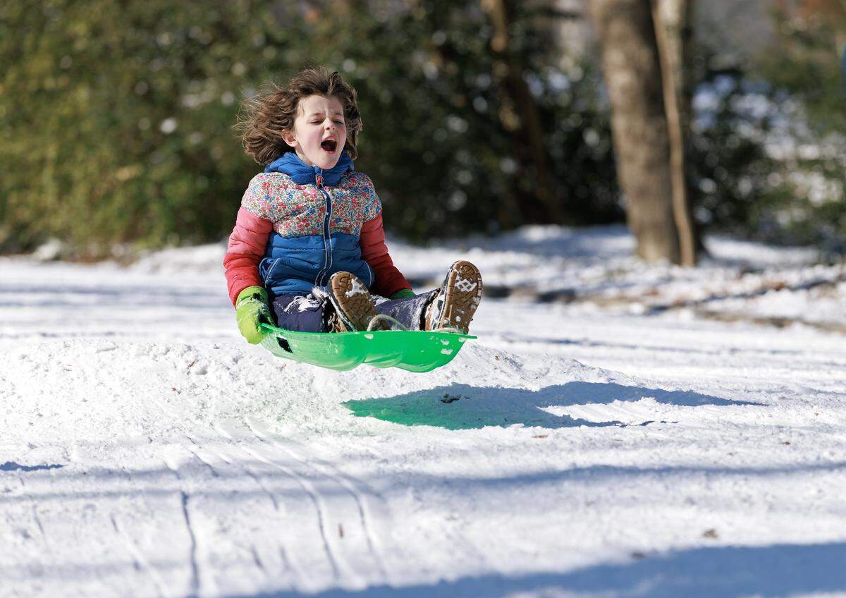 Margot Chappel sleds down Demerius Street on Sunday, Feb. 1, 2026, in Durham, N.C.