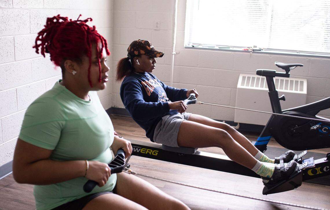 Saint Augustine’s University juniors Drea Taylor, right, and Mikahya Hill, left, use rowing machines to practice technique at their school’s downtown Raleigh, N.C. campus on Monday, April 11, 2022.