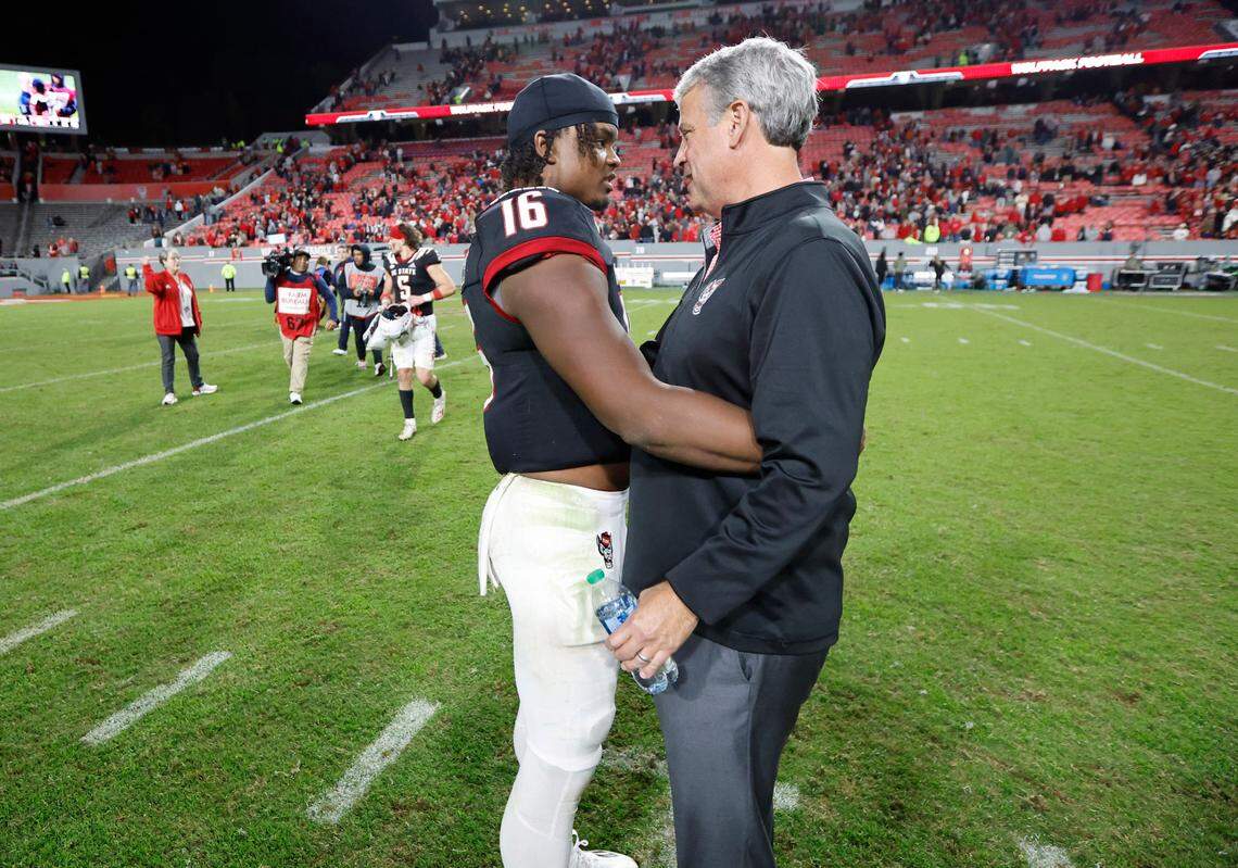 N.C. State athletics director Boo Corrigan talks with quarterback MJ Morris (16) after N.C. State’s 22-21 victory over Virginia Tech at Carter-Finley Stadium in Raleigh, N.C., Thursday, Oct. 27, 2022.