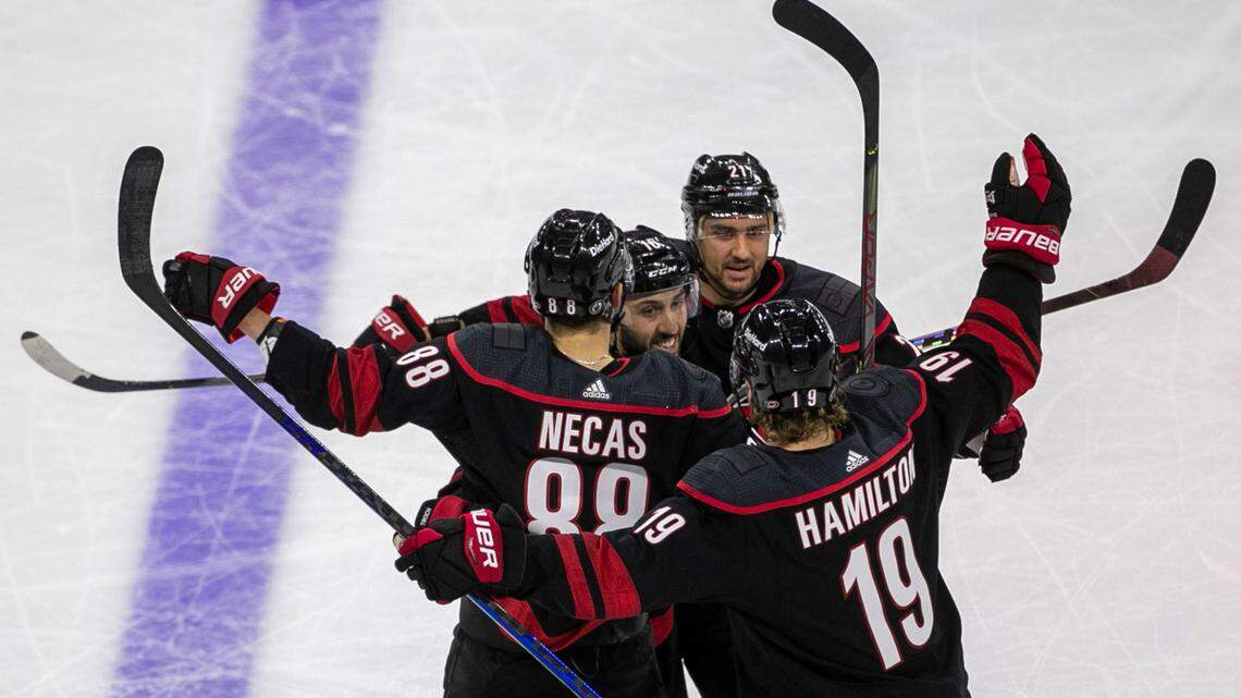 Carolina Hurricanesí Martin Necas (88) is surrounded by teammates Nino Niederreiter (21), Vincent Trocheck (16),and Dougie Hamilton (19) after scoring to tie the score 2-2 in the third period in game five of their first round Stanley Cup Series on Tuesday, May 25, 2021 at PNC Arena in Raleigh, N.C.