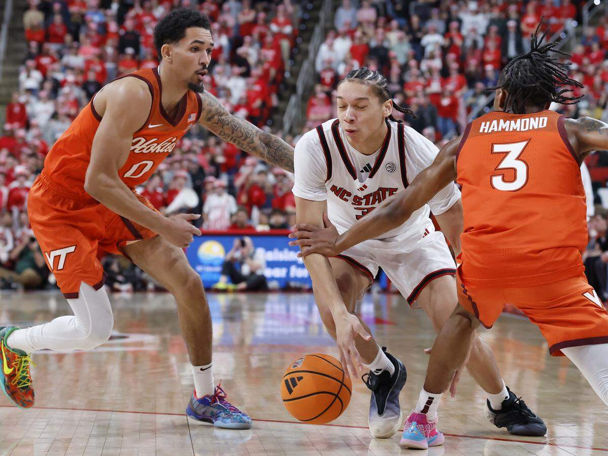 N.C. State’s Matt Able drives between Virginia Tech’s Jailen Bedford and Ben Hammond during the second half of the Wolfpack’s 82-73 win on Saturday, Feb. 7, 2026 at Lenovo Center in Raleigh, N.C. 