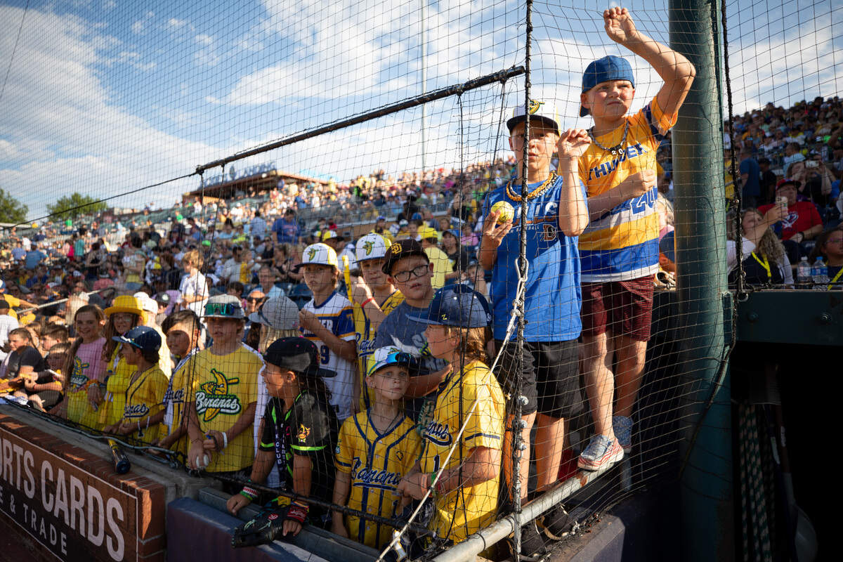 Young fans gather at the net in hopes of meeting Savannah Bananas players ahead of their game at Durham Bulls Athletic Park in Durham, N.C. on Friday, July 14, 2023.