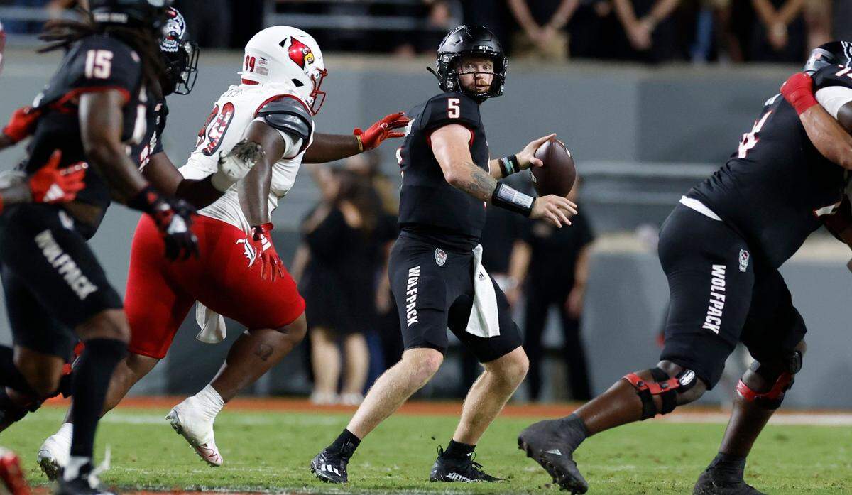 N.C. State quarterback Brennan Armstrong (5) looks downfield to try to throw to wide receiver Keyon Lesane (15) during the first half of N.C. State’s game against Louisville at Carter-Finley Stadium in Raleigh, N.C., Friday, Sept. 29, 2023.