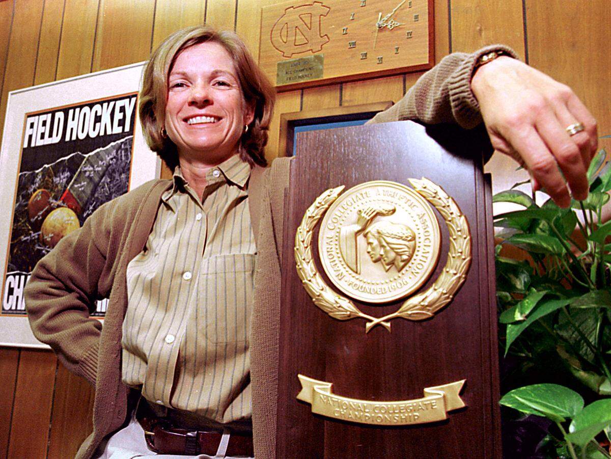 UNC field hockey coach Karen Shelton photographed in 1996 with the NCAA National Championship trophy.