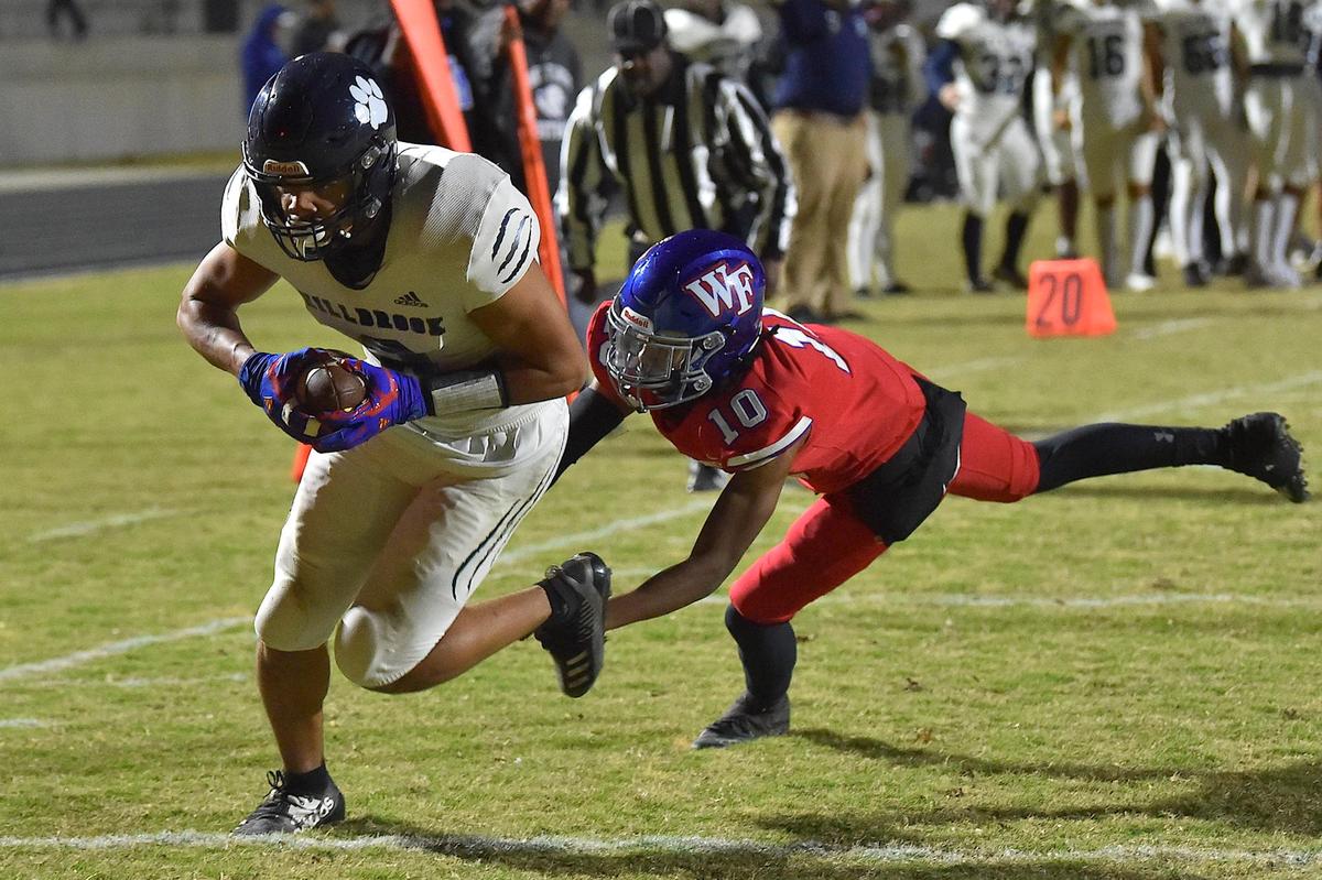 Millbrook wide receiver David Santiago (8) runs for the touchdown against Wake Forest’s Elijah Matlock (10) during the first half. The Wake Forest Cougars and the Millbrook Wildcats met in a football game in Wake Forest, N.C. on October 28, 2022.