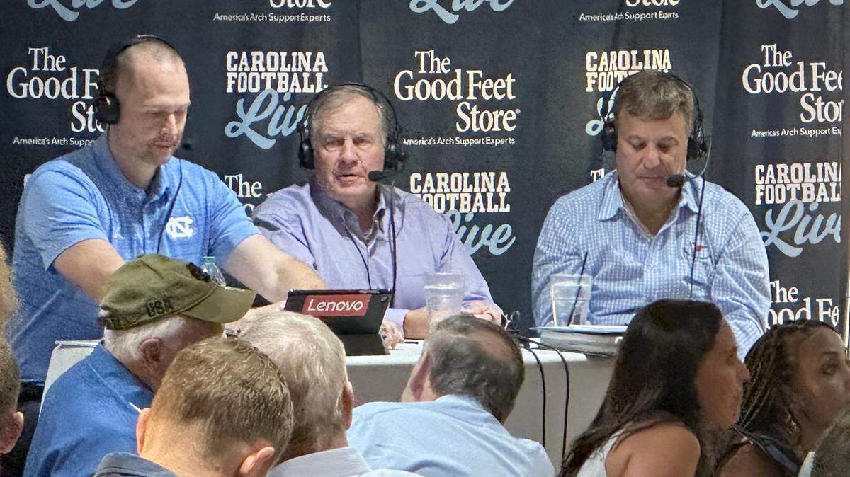 North Carolina head football coach Bill Belichick, center, appears on the “Carolina Football Live” radio show on Wednesday, Aug. 27, 2025, at Top of the Hill Restaurant & Brewery in Chapel Hill, N.C.