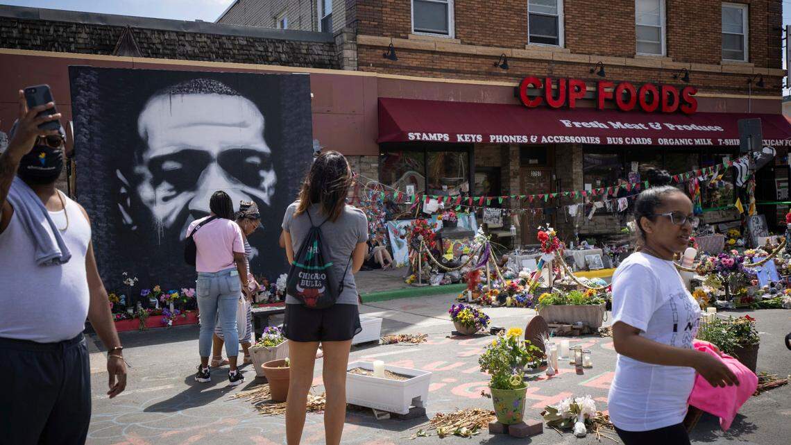 People walk through George Floyd Square after shots were fired on the one year anniversary of George Floyd’s death on Tuesday, May 25, 2021, in Minneapolis. The intersection where George Floyd died was disrupted by gunfire Tuesday, just hours before it was to be the site of a family-friendly street festival marking the anniversary of his death at the hands of police.
