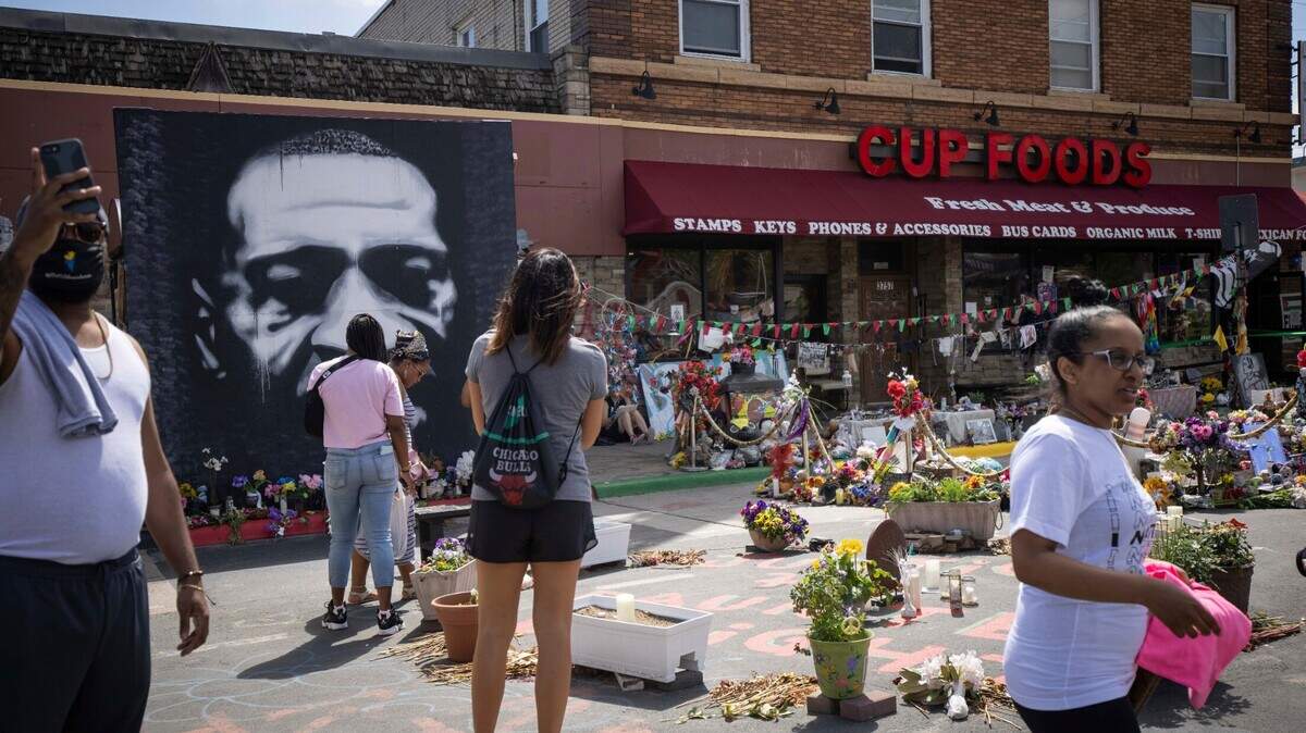 People walk through George Floyd Square after shots were fired on the one year anniversary of George Floyd’s death on Tuesday, May 25, 2021, in Minneapolis. The intersection where George Floyd died was disrupted by gunfire Tuesday, just hours before it was to be the site of a family-friendly street festival marking the anniversary of his death at the hands of police.