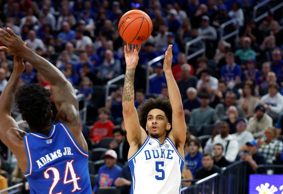 Duke’s Tyrese Proctor (5) shoots a three-pointer during the first half of Duke’s game against Kansas in the Vegas Showdown at T-Mobile Arena in Las Vegas, Nev., Tuesday, Nov. 26, 2024.