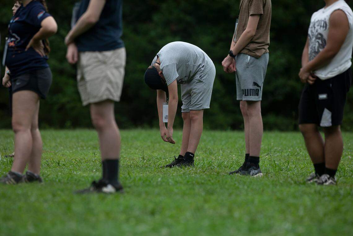 Members of the Jordan High School marching band take a moment of rest during band camp on Friday, July 26, 2024, in Durham, N.C.