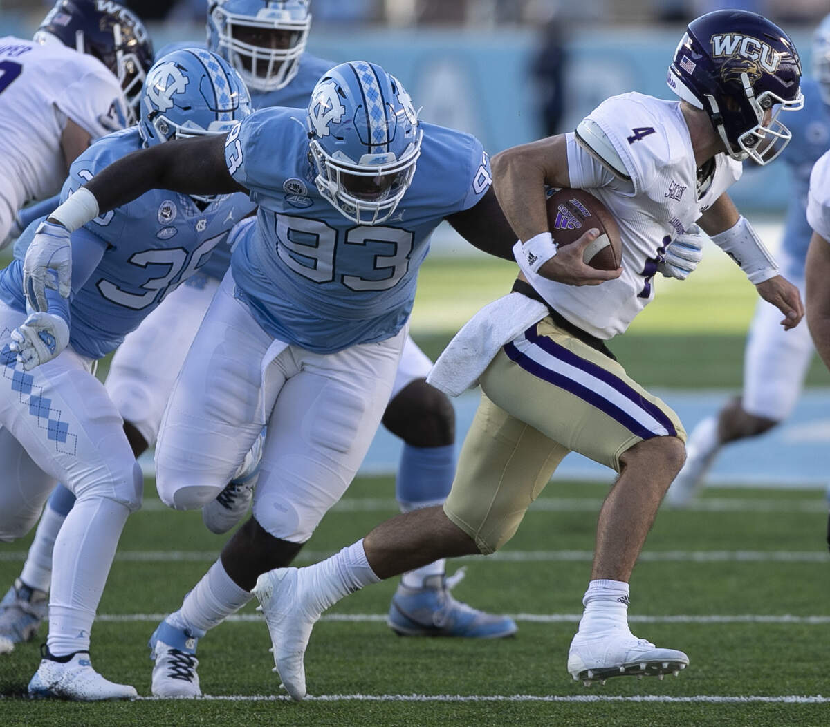 Western Carolina quarterback Kason Lincke (4) is stopped for a loss of five yards by North Carolina’s Kristian Varner (93) in the fourth quarter on Saturday, December 5, 2020 at Kenan Stadium in Chapel Hill, N.
