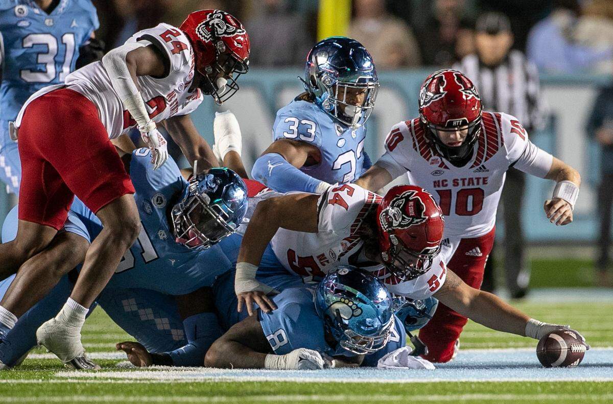 N.C. State’s Dylan McMahon (54) recovers a fumble by quarterback Ben Finley in the third quarter against North Carolina on Friday, November 25, 2022 at Kenan Stadium in Chapel Hill, N.C.