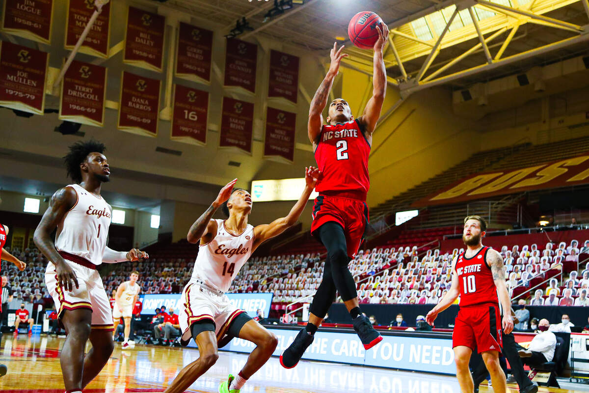 N.C. State’s Shakeel Moore drives past Boston College defender Kamari Williams in first half action Saturday, Feb. 6, 2021.