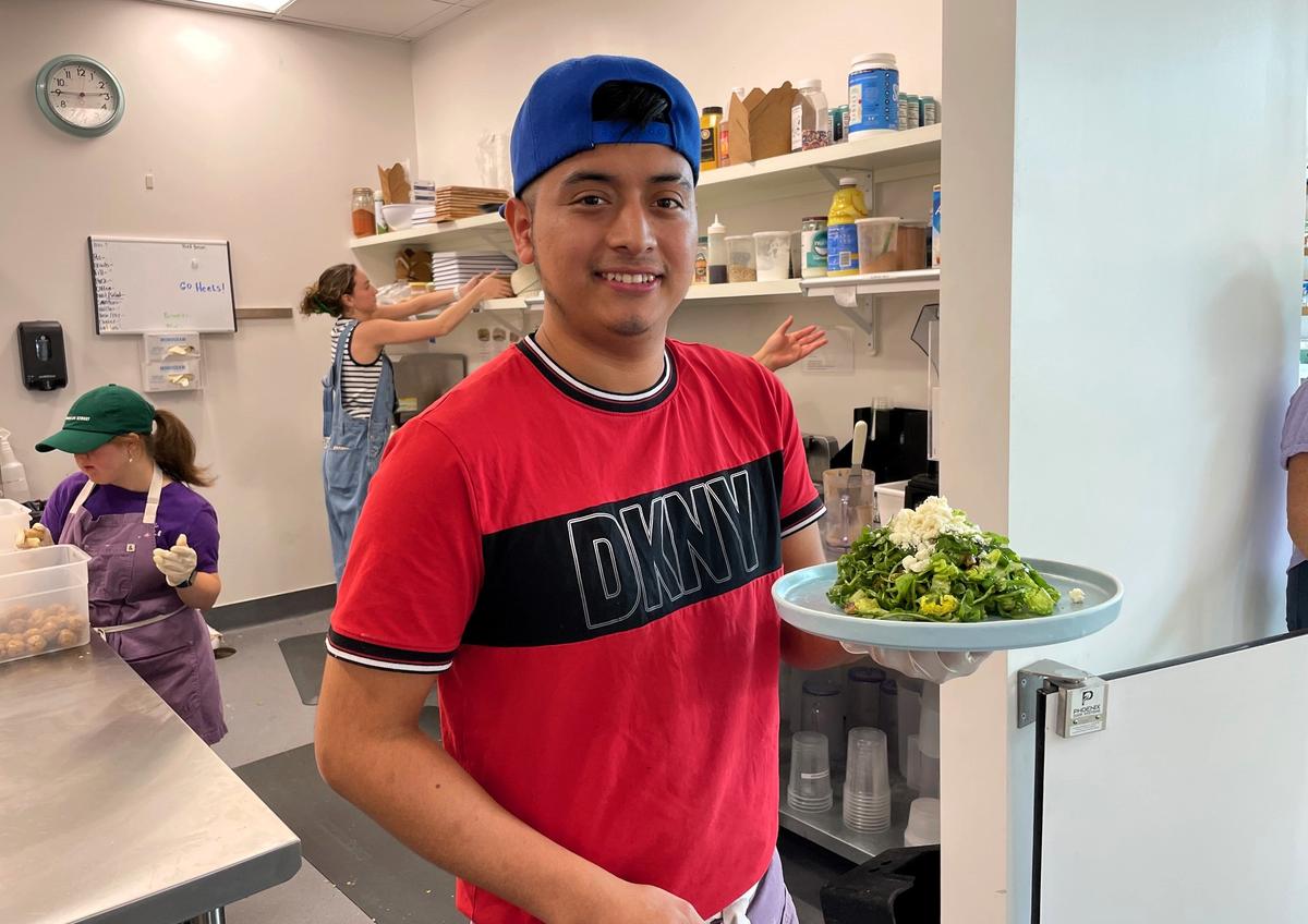 Purple Bowl Kitchen Manager Kevin Gomez shows off a green salad with pistachios, cucumbers, feta cheese and pesto dressing. The Chapel Hill restaurant’s bigger kitchen is an opportunity to add new menu items, owners Paula and Taylor Gilland said.