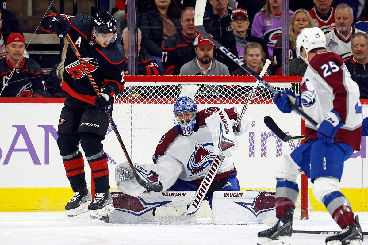 Carolina Hurricanes’ Sebastian Aho (20) tries to deflect the puck past Colorado Avalanche goaltender Pavel Francouz (39) during the first period of an NHL hockey game in Raleigh, N.C., Thursday, Nov. 17, 2022. (AP Photo/Karl B DeBlaker)