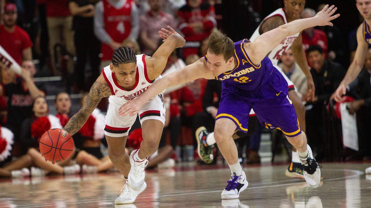 N.C. State’s Blake Harris (55) steals the ball from Lipscomb’s Matt Rose (12) during the first half of the quarterfinals of the NIT on Wednesday night, March 27, 2019 at Reynolds Coliseum in Raleigh, NC.