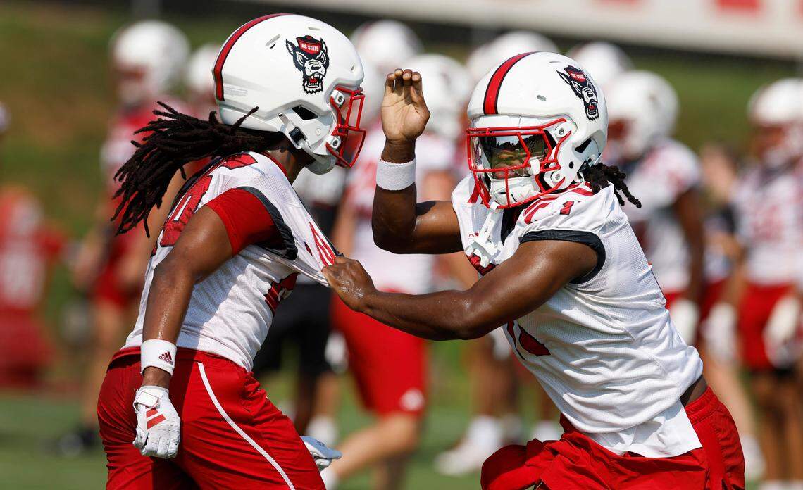 N.C. State safety Ja’Had Carter (11), right, works against cornerback Asaad Brown Jr. (26) during the Wolfpack’s first practice in Raleigh, N.C., Wednesday, July 31, 2024.