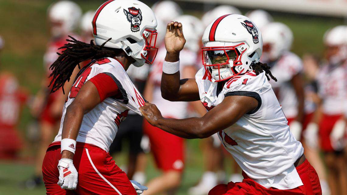 N.C. State safety Ja’Had Carter (11), right, works against cornerback Asaad Brown Jr. (26) during the Wolfpack’s first practice in Raleigh, N.C., Wednesday, July 31, 2024.
