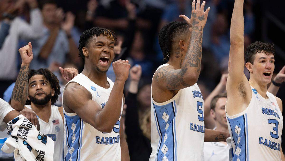 North Carolina’s R.J. Davis (4), Harrison Ingram (55), Armando Bacot (5) and Cormac Ryan (3) react after a basket by reserver player Rob Landry to give the Tar Heels’ a 90-61 lead in the final seconds of play against Wagner on Thursday, March 21, 2024 during the NCAA Tournament at Spectrum Center in Charlotte, N.C.