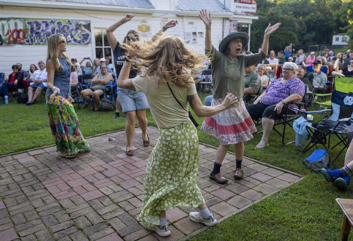 The outdoor dance floor is hoping to the music of the Durham Ukulele Orchestra during the Bynum Front Porch music series on Friday, July 11, 2025 in Bynum, N.C.