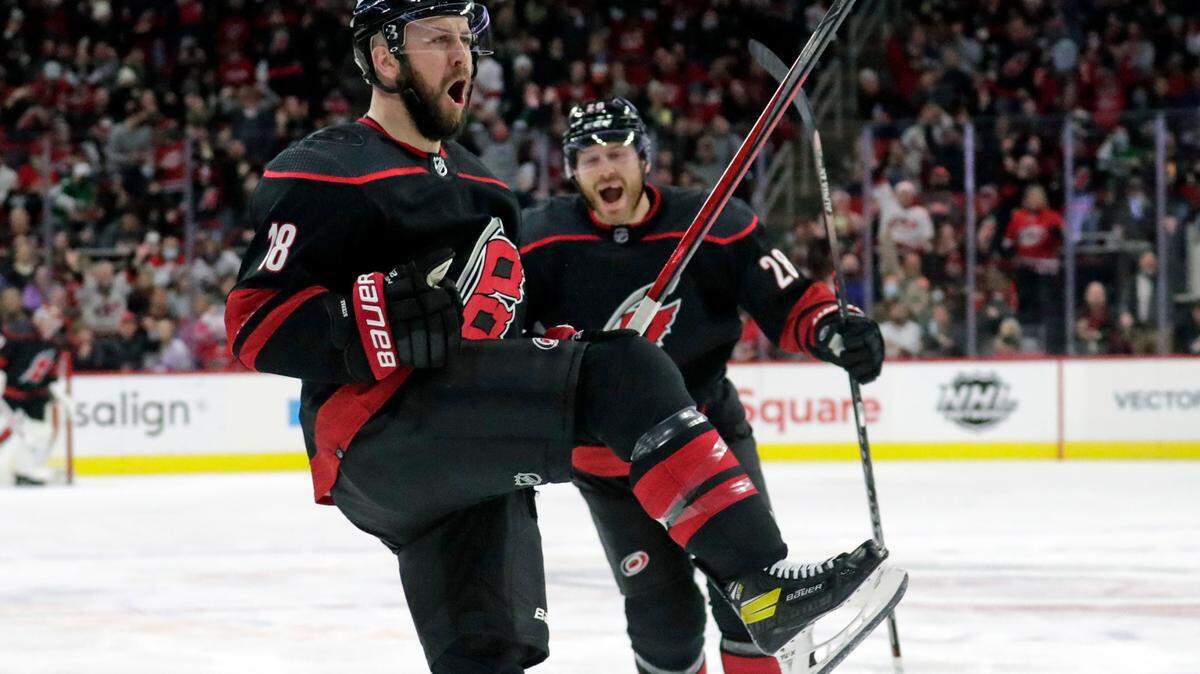 Carolina Hurricanes center Derek Stepan (18) celebrates his goal with defenseman Ian Cole (28) during the second period of the team’s NHL hockey game against the Calgary Flames, Friday, Jan. 7, 2022, in Raleigh, N.C. (AP Photo/Chris Seward)