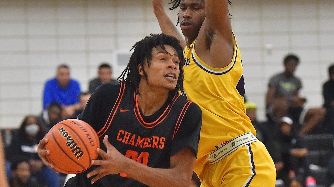 Julius Chambers’ Daniel Sanford (3) drives against Word of God’s Jakwon Moore (24) during the first half. The Word of God Holy Rams and the Julius Chambers Cougars met in the John Wall Holiday Classic in Raleigh, N.C. on December 27, 2021