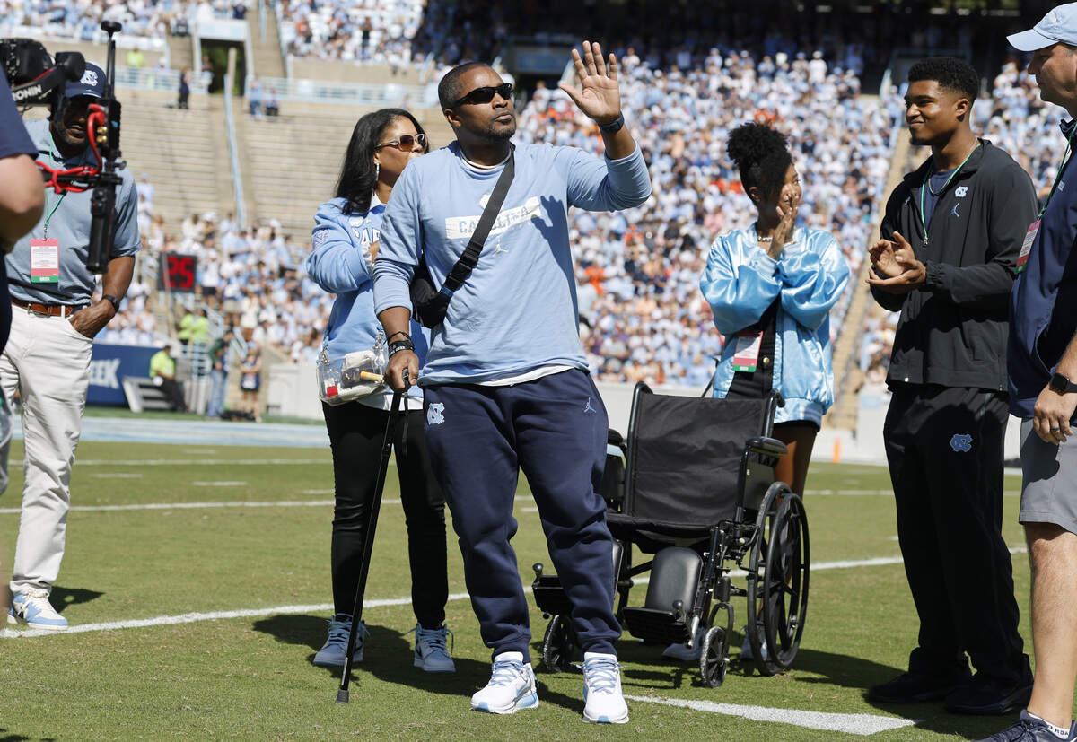 Mitch Mason, North Carolina football’s chaplain, acknowledges the crowd during a ceremony honoring Mason in the first half of UNC’s game against Clemson at Kenan Stadium in Chapel Hill, N.C., Sat. Oct. 4, 2025.