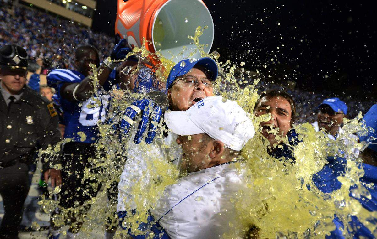 Duke head coach David Cutcliffe gets a dousing by players as time runs off the clock and Duke beats UNC 33-30 at Wallace Wade Stadium in Durham in 2012.