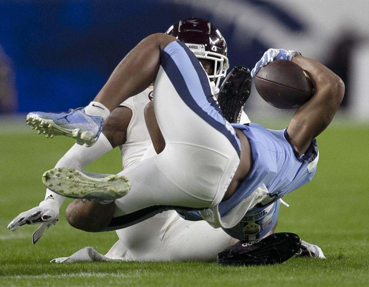 North Carolina’s Josh Downs (11) is stopped by Texas A&M’s Jaylon Jones (17) on third down setting up the Tar Heels’ first field goal in the first quarter in the Capital One Orange Bowl on Saturday, January 2, 2021in Miami Gardens, Florida. 