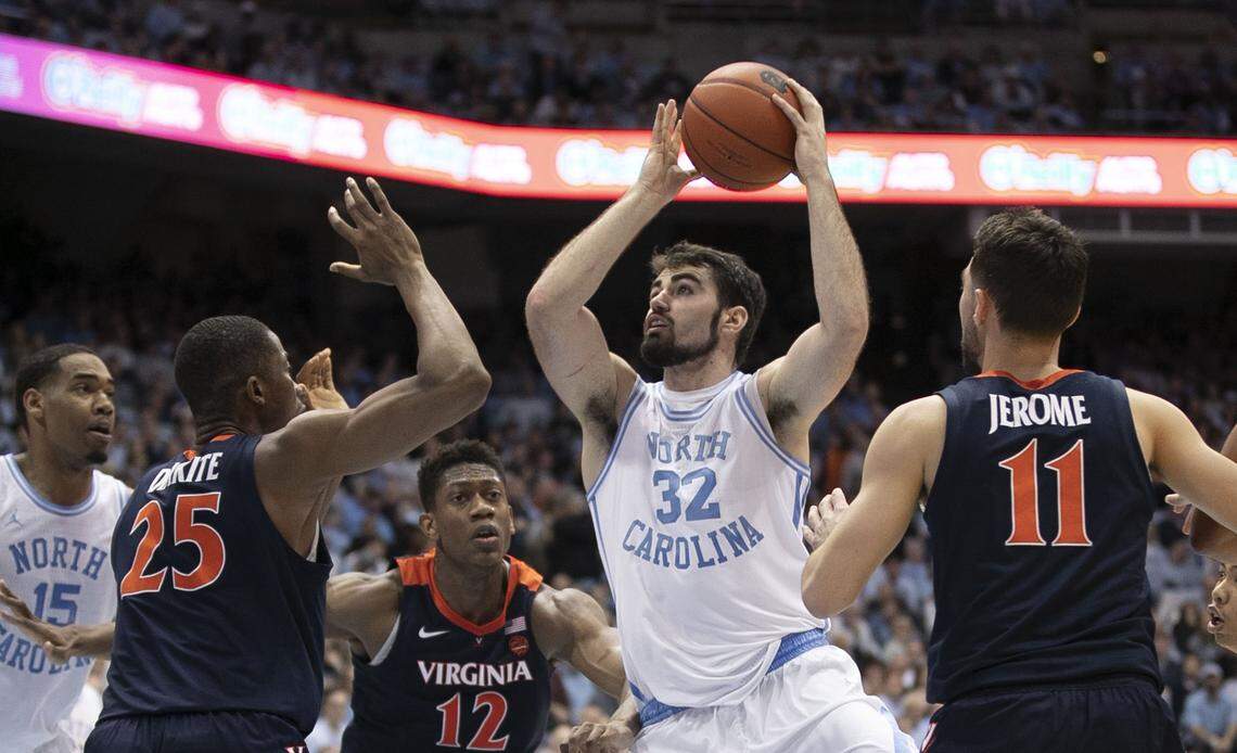 North Carolina’s Luke Maye (32) puts up a shot between Virginia’s Mamadi Diakite (25) and Virginia’s Ty Jerome (11) during the first half on Monday, February 11, 2019 at the Smith Center in Chapel Hill, N.C.