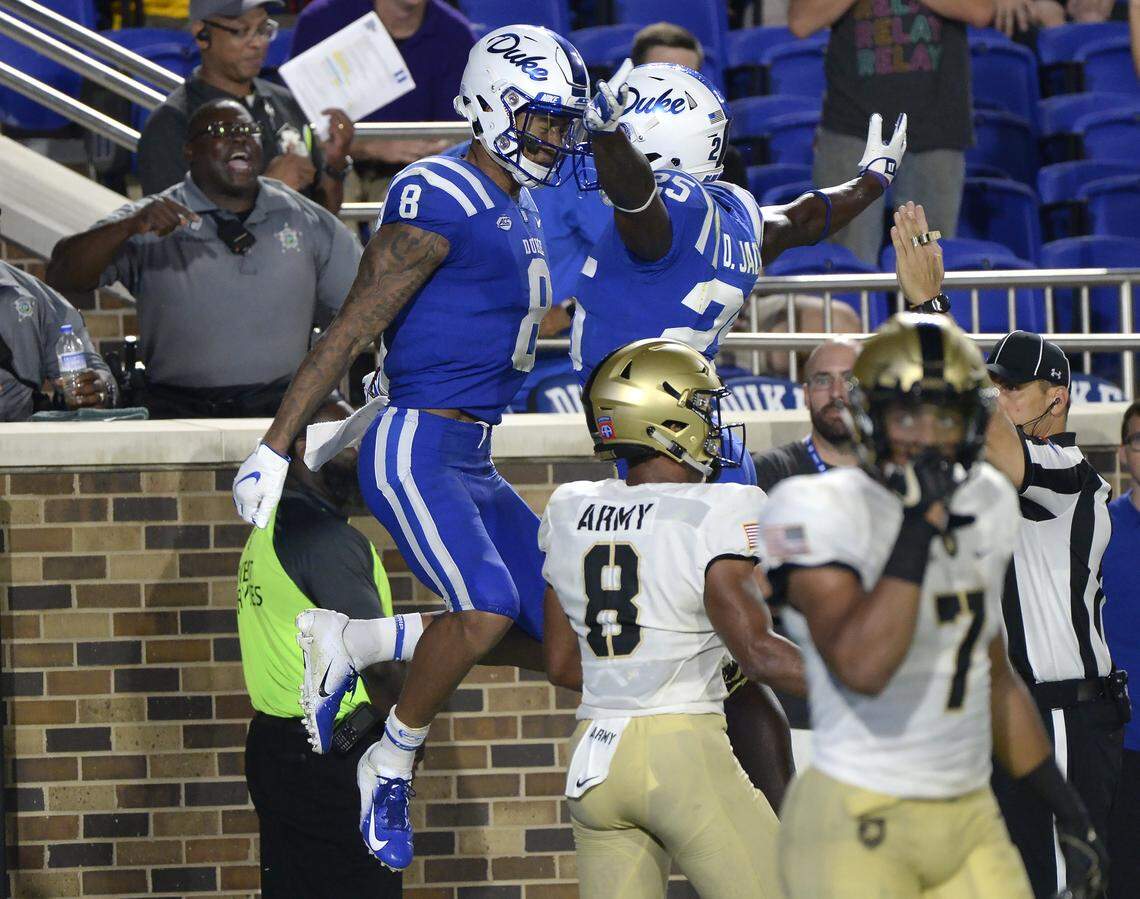 Duke wide receiver Aaron Young (8) celebrates a fourth quarter touchdown with teammate running back Deon Jackson (25). Duke opened the 2018 football season with a win against Army 34-14 at Wallace Wade Stadium in Durham, N.C., Friday, August 31, 2018.