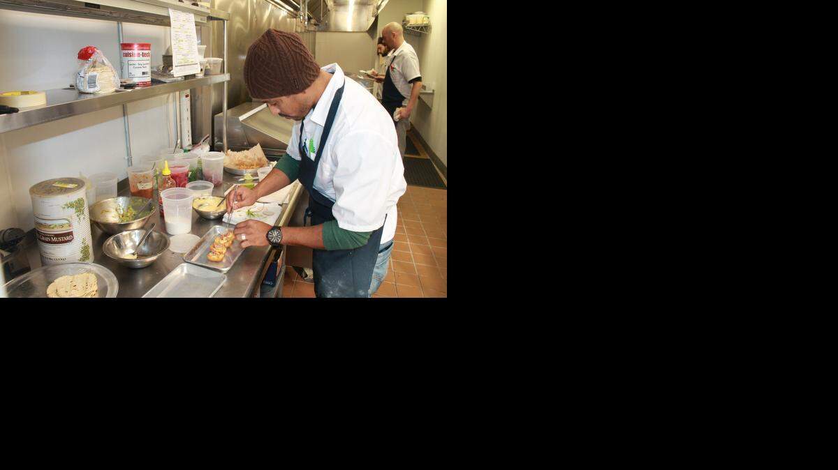 Chef Saif Rahman works on the presentation of fried deviled eggs at Level Up on Wednesday. The restaurant’s management staff was testing menu items in preparation for the place’s opening.
