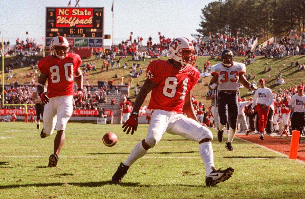 N.C. State’s Torry Holt crosses the end zone for the first of his touchdowns during a game against Virginia.