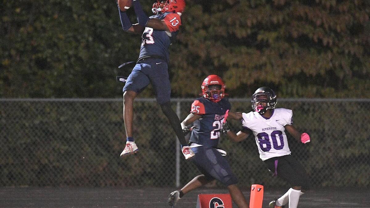 Jordan’s Dyllan Jones (13) intercepts the pass intended for Riverside’s Jaleel Griffin (80) late in the second half.The Riverside Pirates and the Jordan Falcons met in a conference football game in Durham, N.C. on October 13, 2023.
