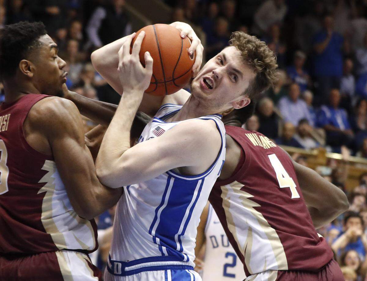 Duke’s Matthew Hurt (21) pulls in the rebound from Florida State’s Trent Forrest (3) and Patrick Williams (4) as he is fouled with 12 seconds left in the game during Duke’s 70-65 victory over Florida State at Cameron Indoor Stadium in Durham, N.C., Monday, Feb. 10, 2020.