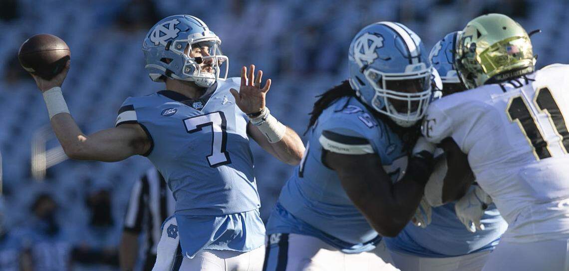North Carolina quarterback Sam Howell (7) gets protection from lineman Joshua Ezeudu (75) in the fourth quarter against Wake Forest at Kenan Stadium on Saturday, November 14, 2020 in Chapel Hill, N.C. Howell completed 32 of 45 passes for 550 yards and 6 touchdowns in the Tar Heels; 59-53 victory. 