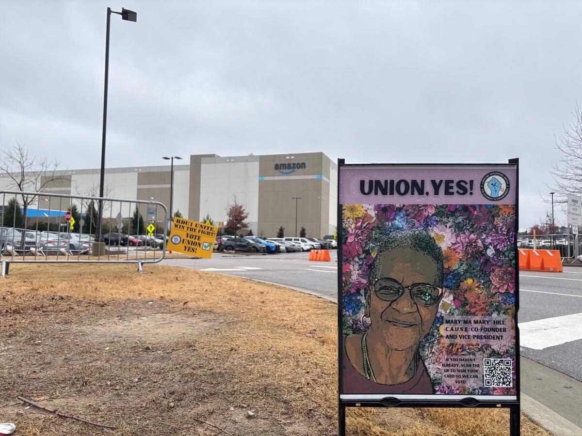 A poster featuring union organizer Mary Hill encourages workers to vote for the union during a week-long election at Amazon’s RDU1 fulfillment center in Garner, North Carolina.