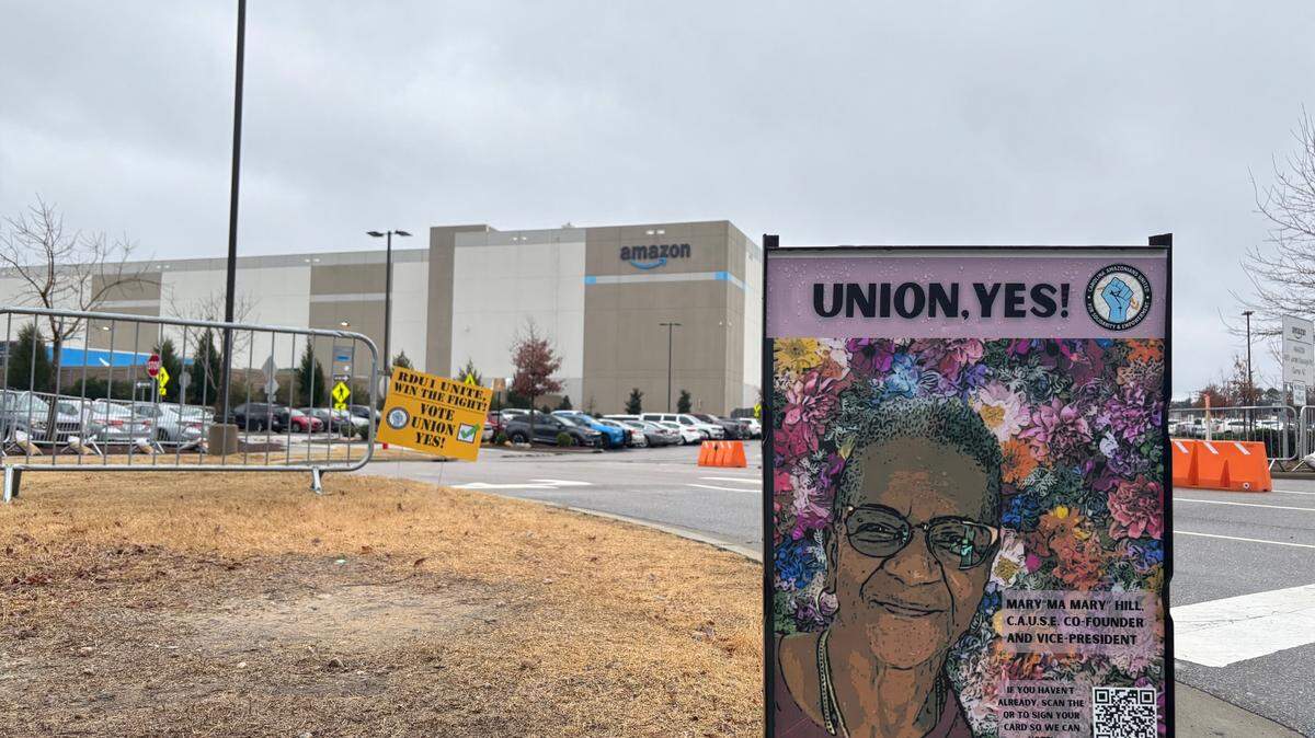 A poster featuring union organizer Mary Hill encourages workers to vote for the union during a weeklong election at Amazon’s RDU1 fulfillment center in Garner, North Carolina.