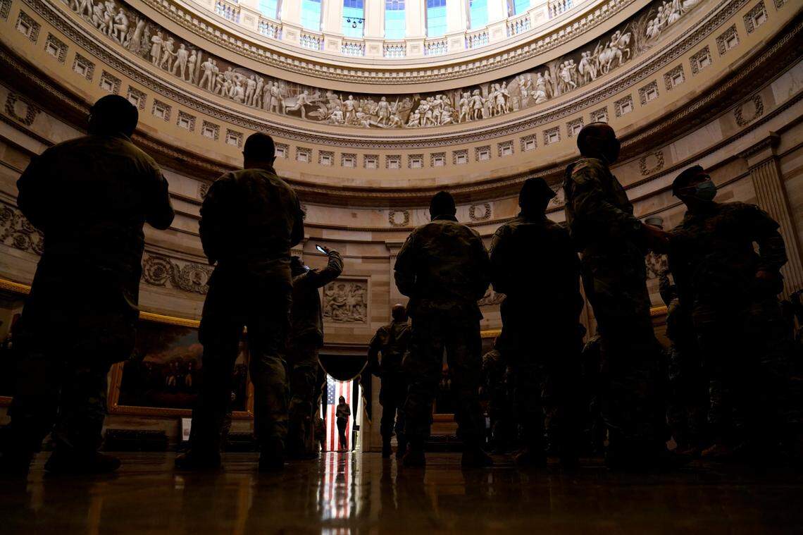 Troops stand in the Capitol Rotunda as they reinforce security at the Capitol in Washington, Wednesday, Jan. 13, 2021. President Donald Trump was impeached by the U.S. House for a historic second time Wednesday, charged with “incitement of insurrection” over the deadly mob siege of the Capitol in a swift and stunning collapse of his final days in office.