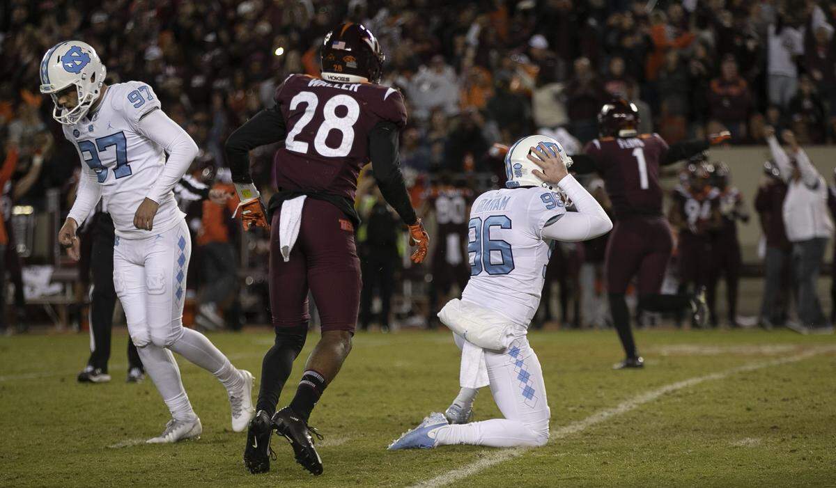 North Carolina kicker Noah Ruggles (97) and holder Cooper Graham (96) react after his 44-yard attempt was blocked by Virginia Tech’s Jermaine Waller in the fourth overtime on Saturday, October 19, 2019 at Lane Stadium in Blacksburg, Va.