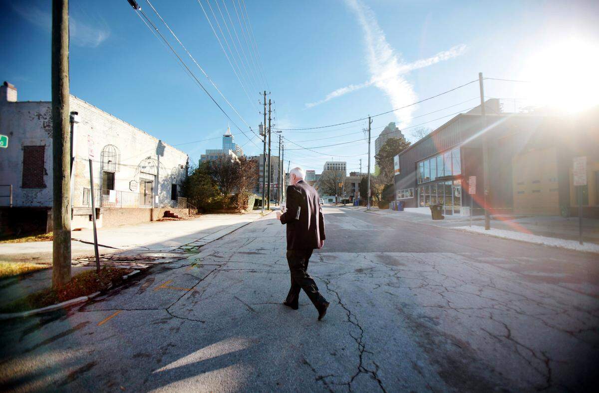 Steve Schuster heads back to his office in downtown Raleigh Wednesday morning, December 16, 2014, after picking up his second cup of coffee from Videri Chocolate Factory across the street. Schuster’s firm, Clearscapes, renovated Videri’s space on West Davie Street.