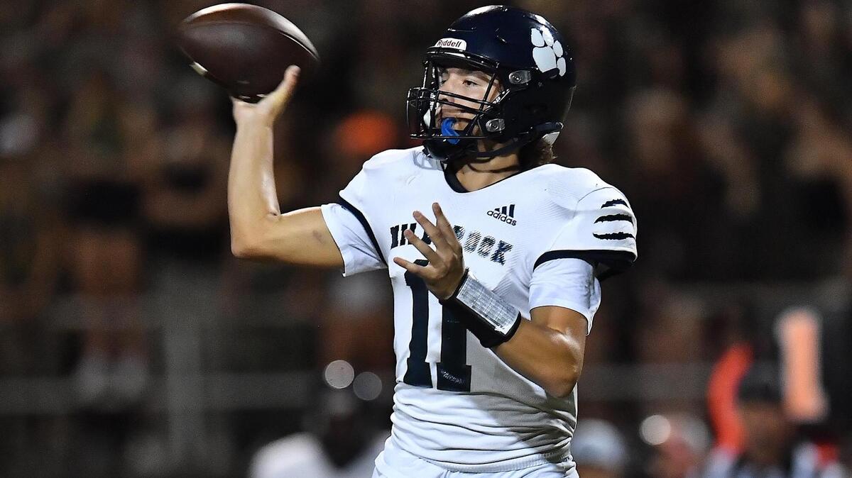 Millbrook’s Mason Fortune (11) passes the ball against Sanderson during the first half. The Sanderson Spartans and the Millbrook Wildcats met in a football game in Raleigh, N.C. on September 16, 2022.