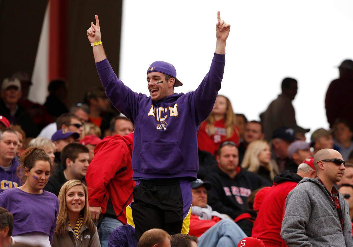 ECU fans celebrate during the Pirates’ 42-28 victory over N.C. State at Carter-Finley Stadium in 2013.