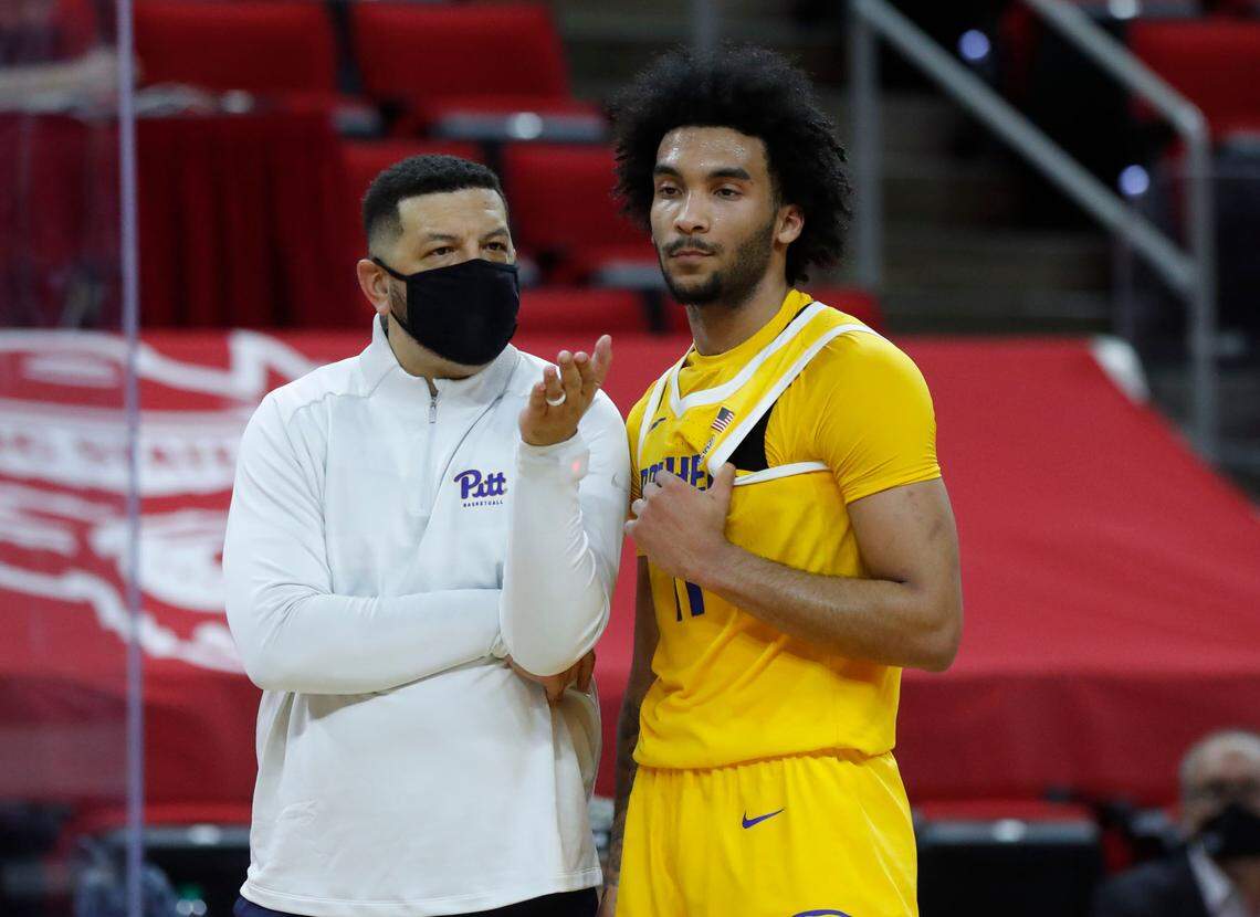Pittsburgh’s head coach Jeff Capel talks with Justin Champagnie (11) after a technical was assessed during the first half of N.C. State’s game against Pittsburgh at PNC Arena in Raleigh, N.C., Sunday, February 28, 2021.
